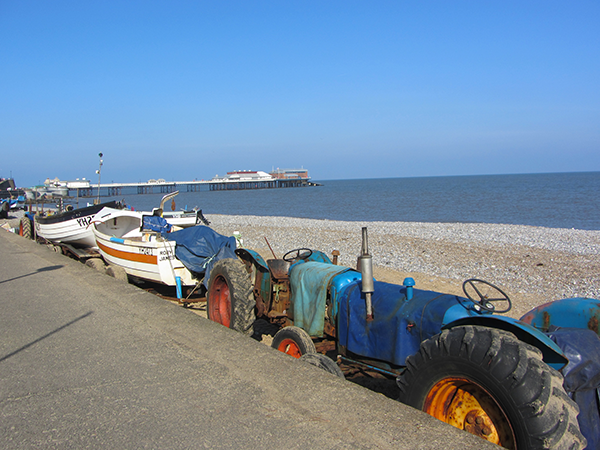 Fishing livelihoods continue whilst you walk! Cromer Pier and tractors on Cromer beach